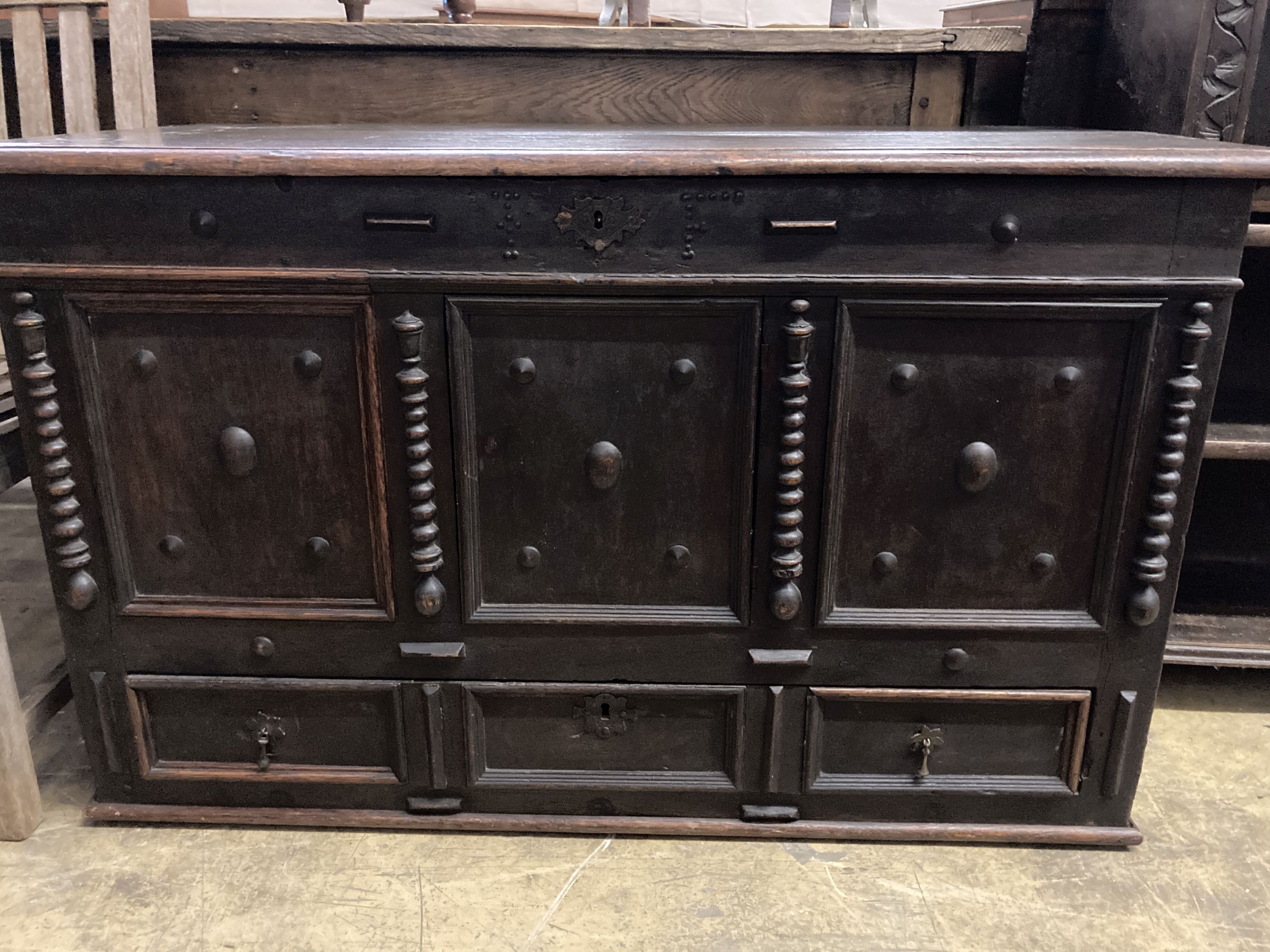 An 18th century panelled oak mule chest, length 117cm, depth 56cm, height 70cm